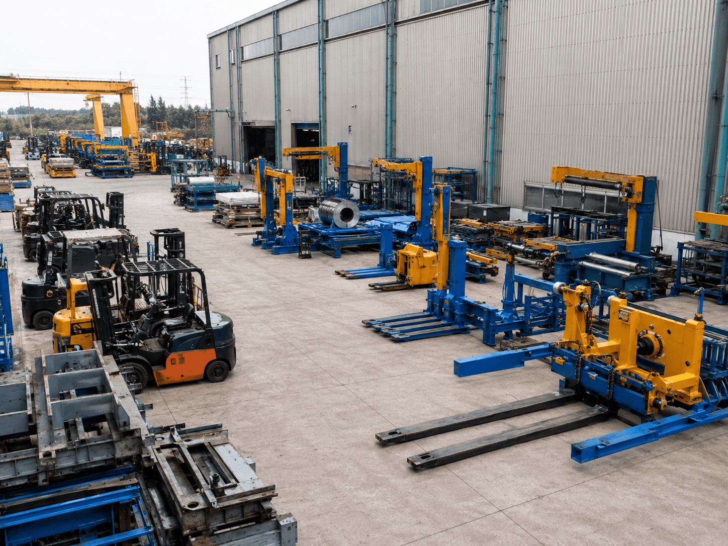 Industrial lifting equipment staged outside a facility, representing heavy-duty production environments