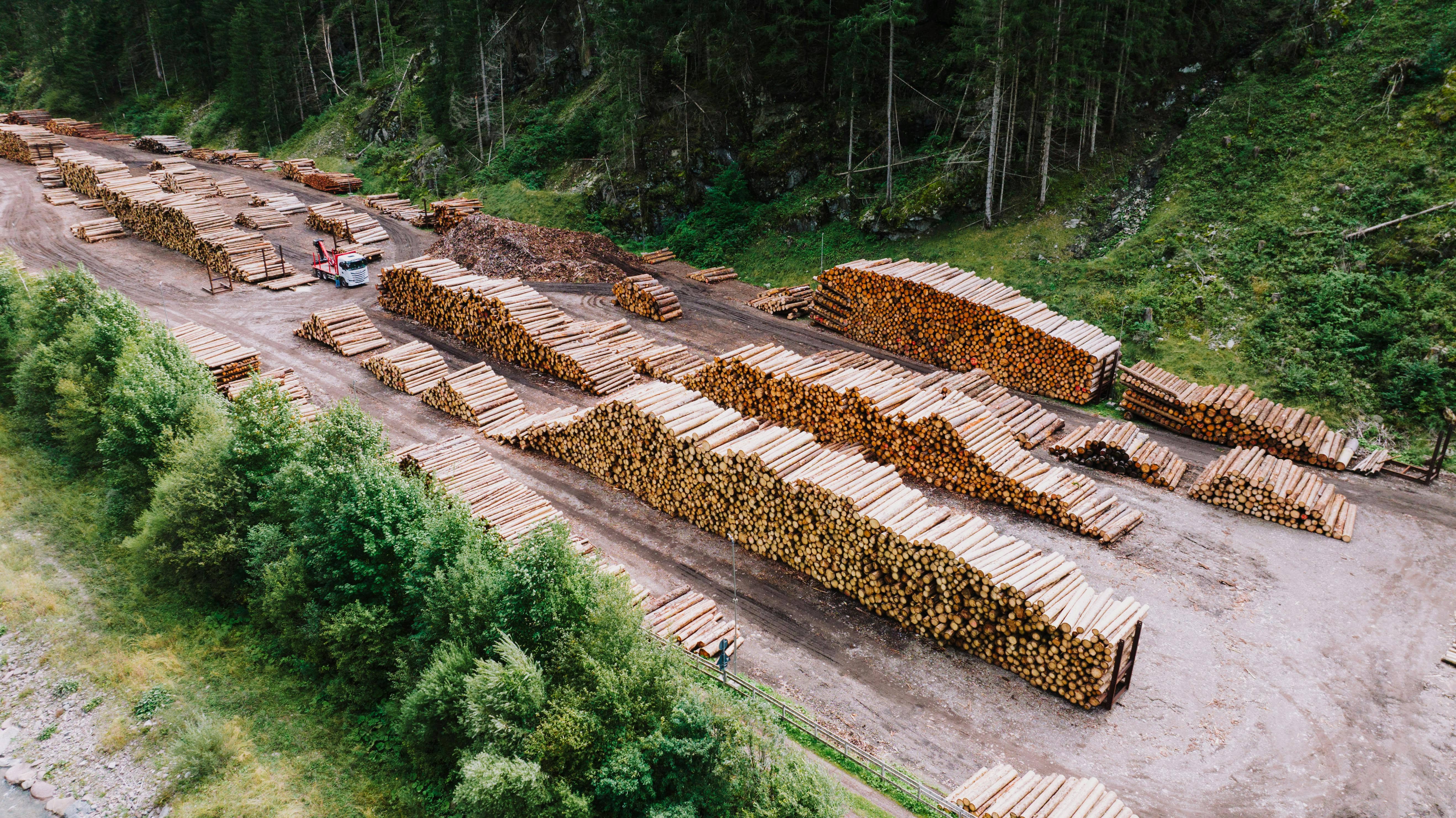 Organized lumber yard area with building materials, boards, and jobsite supply inventory