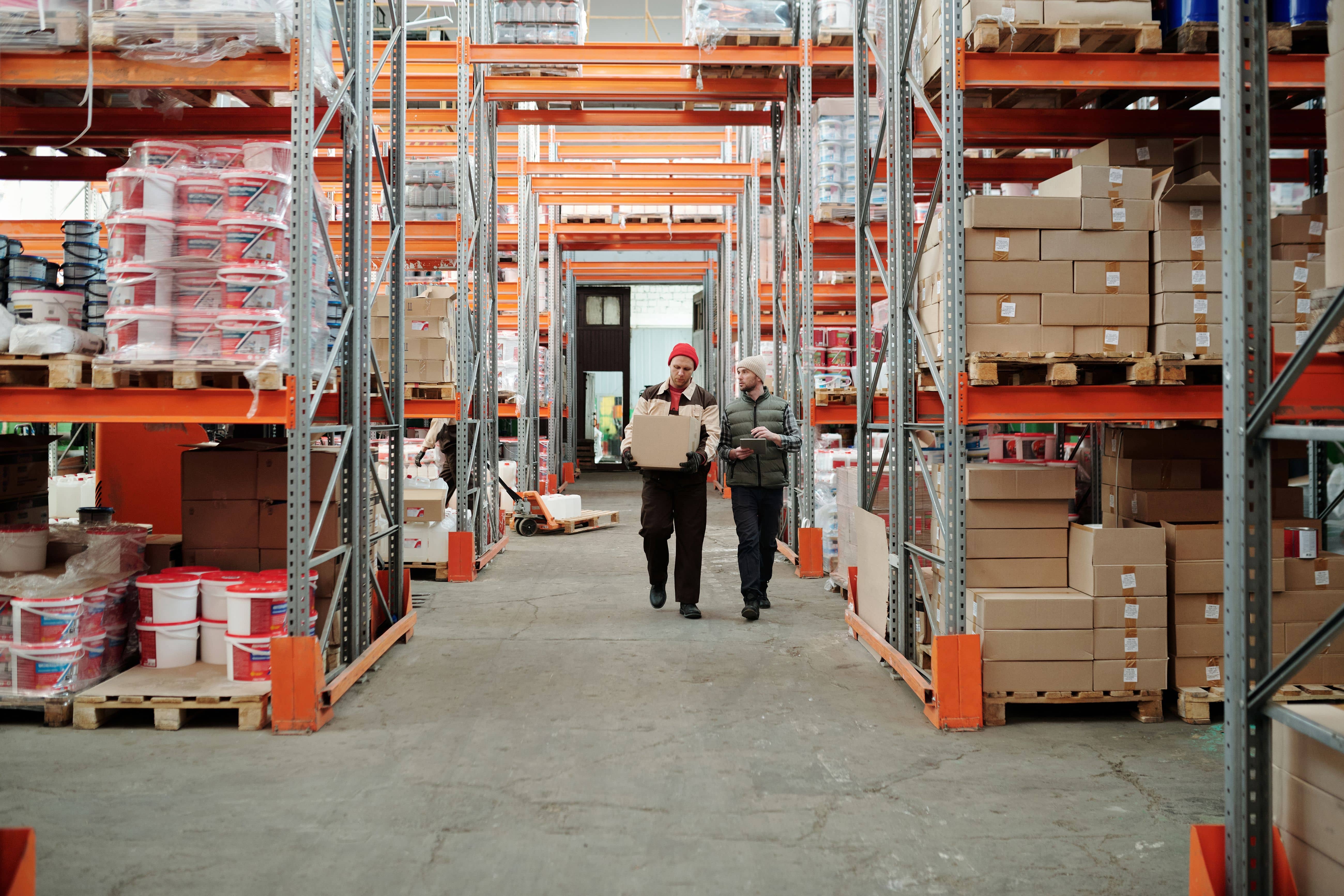 Warehouse storage racks with a forklift moving palletized freight through an organized logistics facility